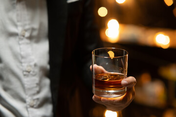 Businessman sitting and holding glass of whiskey