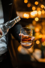 Businessman sitting and holding glass of whiskey