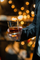 Businessman sitting and holding glass of whiskey