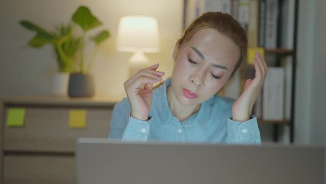 businesswoman asia busy late night working on desk laptop computer in chronic suffer burnout brownout office syndrome anxiety workforce at home.&nbsp;