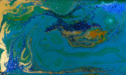 Blue and Gold Glitter on Liquid Blue Ink Background.