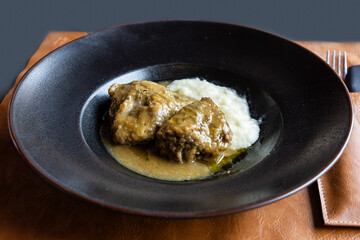 Simple serving portion of slow roasted pork steak with gravy, an Italian delicacy in Montepulciano Tuscany