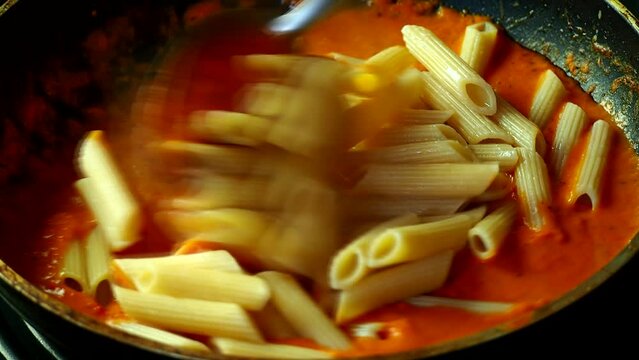 Cooking pasta with fine sauce in pan, in door  Chiangmai  Thailand.