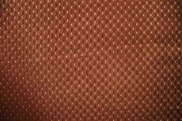 Fototapeta premium Polka dots design ande texture on a brown cloth for background