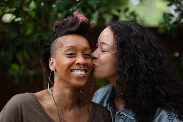 A lesbian couple celebrate their engagement with joyful and romantic photos in a backyard. They...