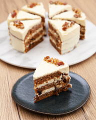 Classic carrot cake with cream cheese frosting, pecan, walnut and raisin