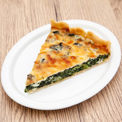 a piece of classic spinach quiche
