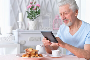 senior man using tablet