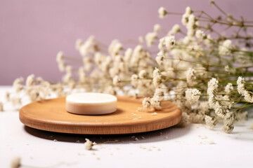 Beauty cosmetic product presentation scene made with a wooden plate and wild flowers, Summer mood background, Front view