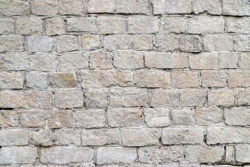 Old white stone wall made of gang-sawn structural stone as an architectural background