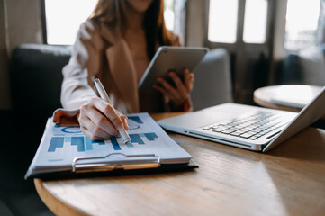 Businesswoman working with VR wide blank screen tablet, computer and smart phone on office blur background.