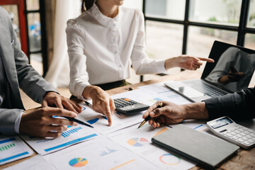 Business people meeting at office writing notes about sticky notes Laptop,tablet  Planning and Brainstorming Strategies of Colleagues in office.