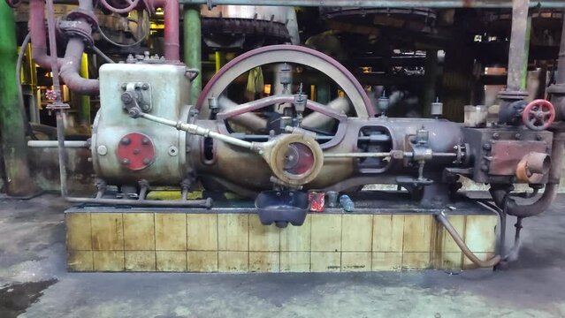 Steam engine driving an air compressor in a sugar industry factory.