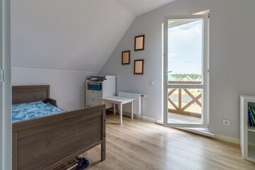 Modern bedroom in a new house in bright colors with a minimum amount of furniture
