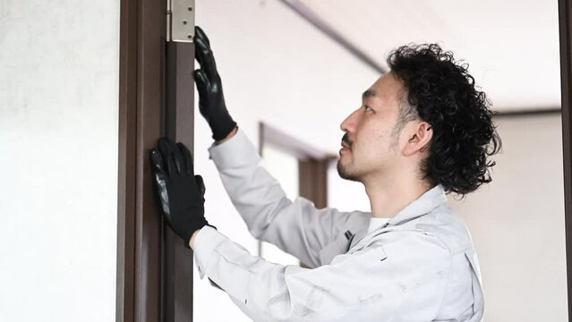 Workers checking and repairing door hinges Image of interior decorator, etc. video