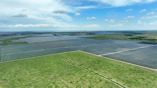 Sprawling solar farm. Aerial wide shot of endless rows of solar panels generating clean and renewable energy for USA cities.