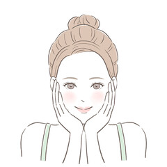 顔に手を当ててスキンケアする女性