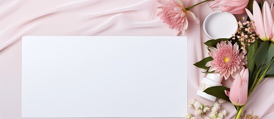 Photo of pink flowers and a white card on a pink background with copy space with copy space
