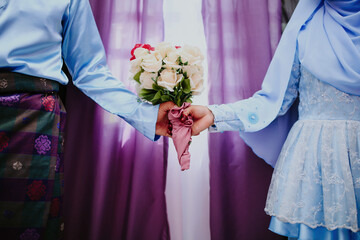 Malay wedding theme, holding hands newlyweds.