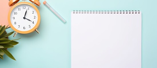 Photo of a notepad and alarm clock on a desk with copy space for your ideas and reminders with copy space