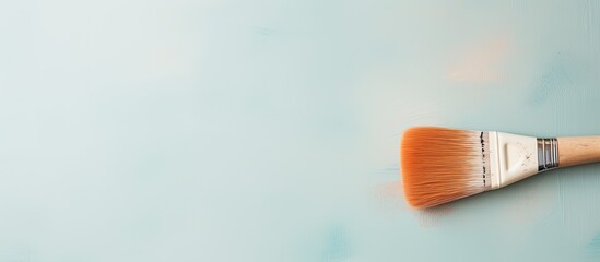 Photo of a paintbrush on a vibrant blue background, perfect for creative projects and artistic inspiration with copy space