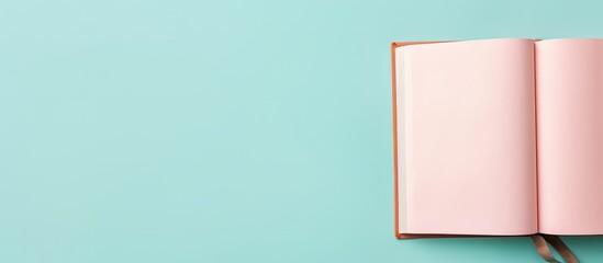 Photo of an open pink book on a vibrant blue background with plenty of copy space with copy space