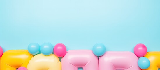 Photo of colorful letter shaped balloons floating in the air with copy space