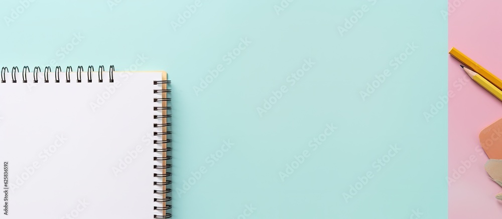 Poster photo of a notebook and pencil on a pastel blue and pink background with plenty of copy space with c