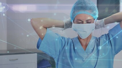 Animation of data processing over caucasian female surgeon in face mask - Powered by Adobe