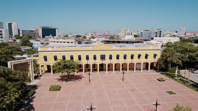 Aerial shot captures the vibrant Plaza de la Aduana in Barranquilla, Colombia. The bustling square is surrounded by historic buildings and colourful streets, creating a lively and energetic atmosphere