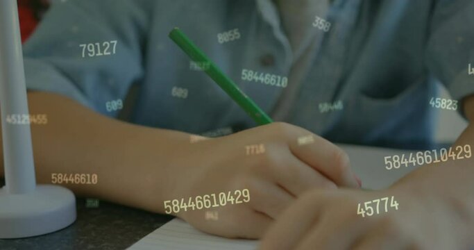 Animation of numbers over caucasian schoolboy writing