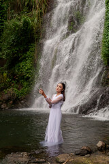 Young Girl in White Shirt poses near Jagir Waterfall in Banyuwangi