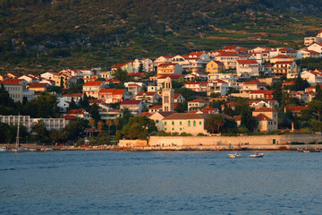 Fototapeta na wymiar Small picturesque town Hvar on island Hvar, Croatia, illuminated by warm sunset light.