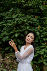 Young Girl in White Shirt poses near Jagir Waterfall in Banyuwangi