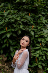 Young Girl in White Shirt poses near Jagir Waterfall in Banyuwangi