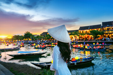 Asian woman wearing vietnam culture traditional at Hoi An ancient town,Hoi an city in Vietnam. - obrazy, fototapety, plakaty