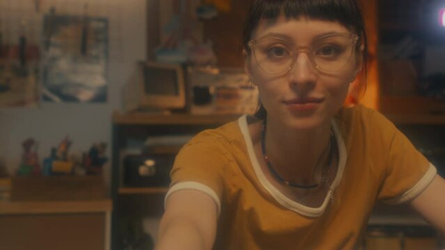 CGI shot of young Caucasian female programmer wearing yellow T-shirt and eyeglasses inserting floppy disc and seeing code appeared on screen