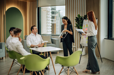 In diverse workspace, project manager presents eco-friendly solar panels, and sustainable solutions