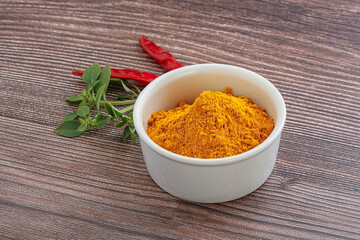 Yellow vibrant curcuma powder in the bowl