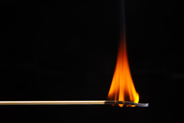 Burning wood match on a dark background close-up. burning tree fire