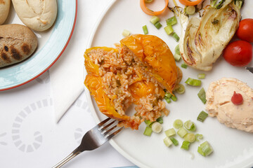 Very delicious Greek bell peppers with a simple rice filling served with cheese and vegetables