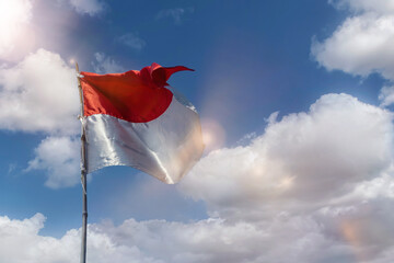 Flag of the republic indonesia with blue sky as background