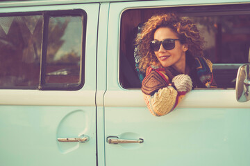 Retro classic travel vehicle and people concept. One Beautiful adult woman inside a blue van....