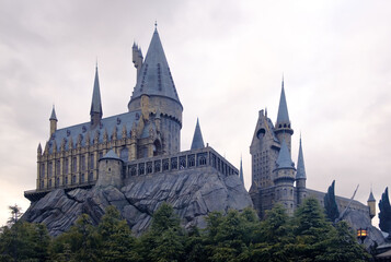 Obraz premium OSAKA, JAPAN - 02022023: Universal Studios Japan . The Hogwarts castle reflect to the water in The Wizarding World of Harry Potter in Universal Studio Osaka