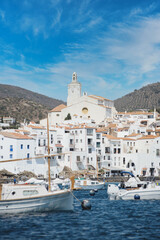 White village of Cadaqués, Costa Brava, Spain, fishing boats and yachts on the beach.