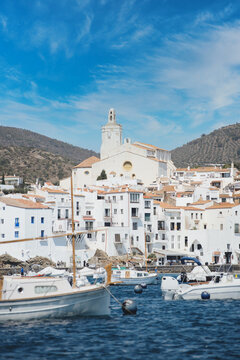 White village of Cadaqués, Costa Brava, Spain, fishing boats and yachts on the beach.