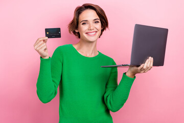 Naklejka premium Photo of cheerful shiny girl dressed green sweater online shopping apple samsung modern gadget isolated pink color background
