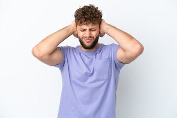 Young handsome caucasian man isolated on white background frustrated and covering ears