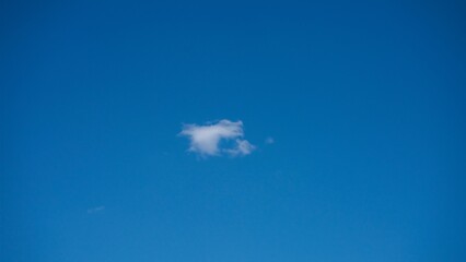 Small, fluffy and lonely clouds in the blue sky.