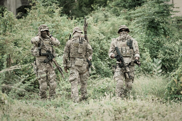Fototapeta premium United States Army ranger during the military operation. Professional marine soldiers training with weapon on a military range.